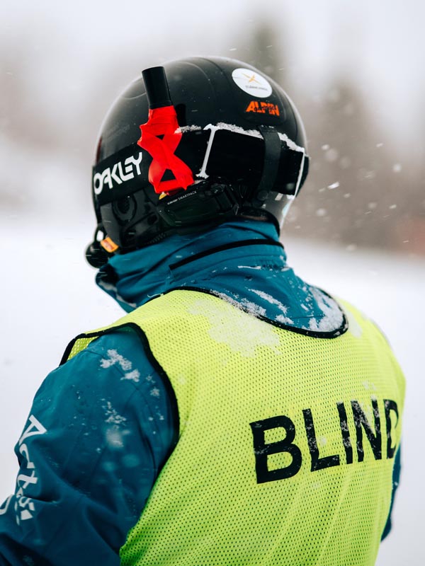 blind person skiing with digital guide gps module on helmet